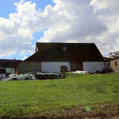 a car parked in front of a house on a hill