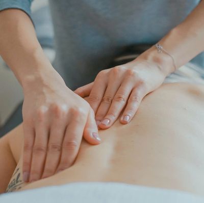 Hands giving a relaxing back massage.