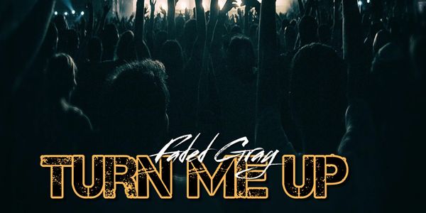 Crowd raising hands at a concert with 'Turn Me Up' text overlay.