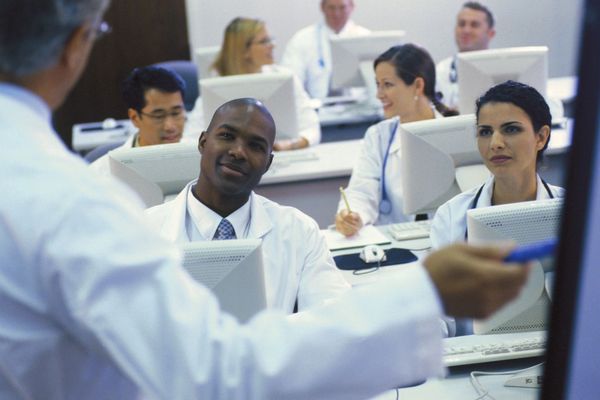 Portrait of doctors, different age who writing exercises at lesson in university