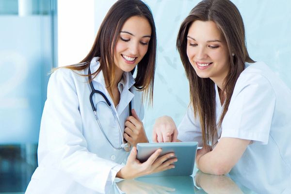 Medical and nurse looking for something on a digital tablet at the hospital
