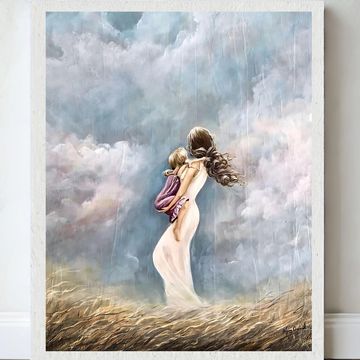 Woman holding a child in a stormy field.