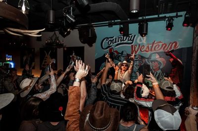 Crowd enjoying live music at a country-western bar.