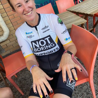 Cyclist in the Not Boring Supports kit with matching coloured nails of black and yellow to match kit