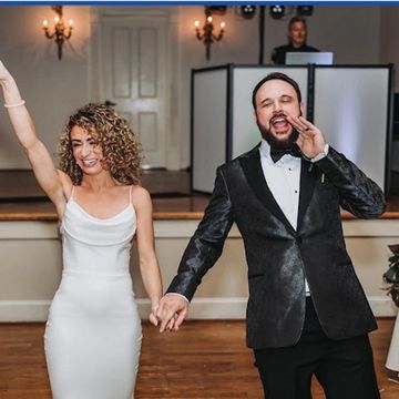 Bride and Groom waving and smiling while being introduced for the first time.