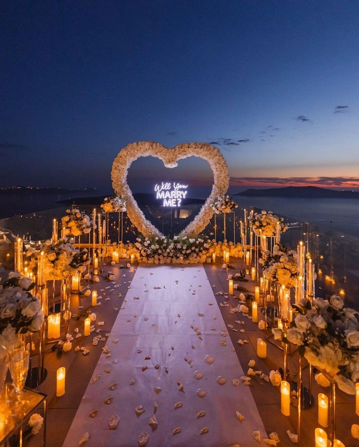 Romantic marriage proposal setup with heart and candles.