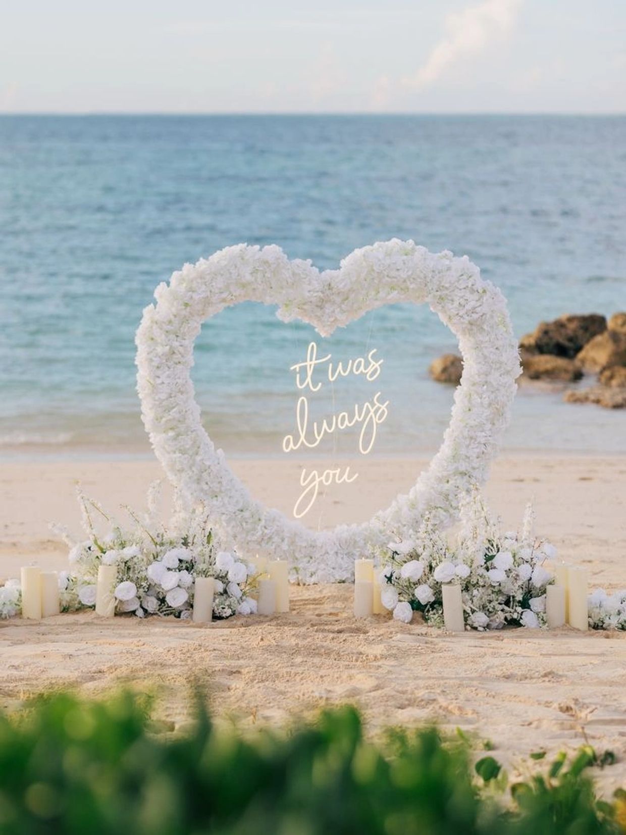 White floral heart frame with "it was always you" text on beach.