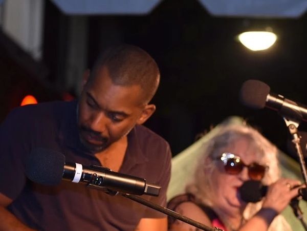 Two people singing into microphones.