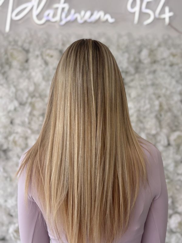Long, straight blonde hair viewed from the back.