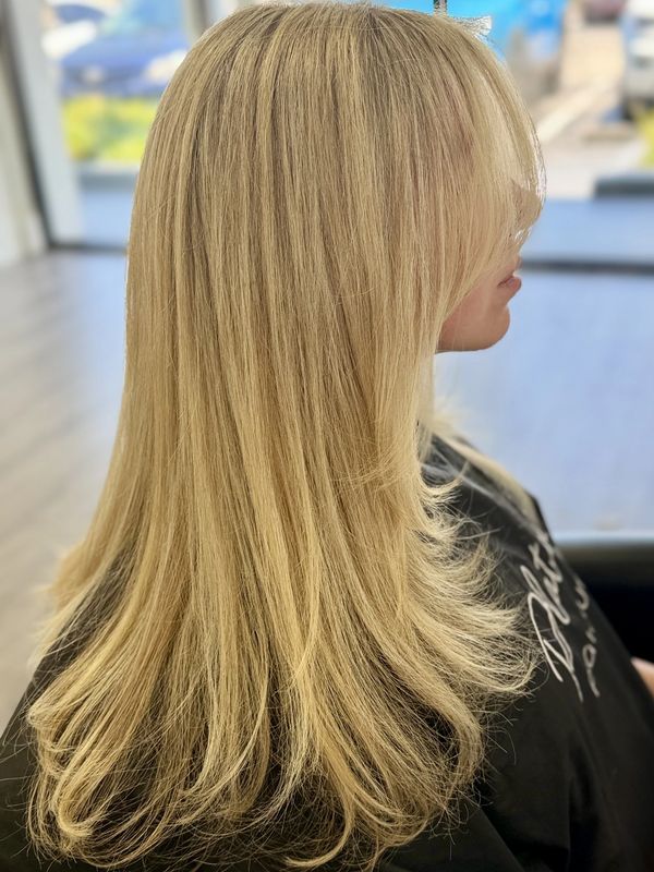 Dimensional blonde full highlight with layered haircut back view at Platinum 954 Hair Salon
