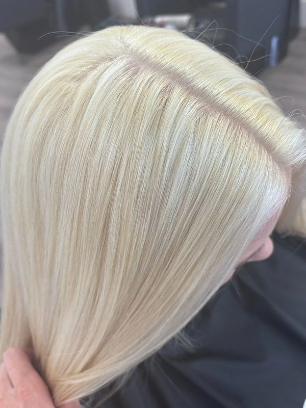 Platinum blonde hair with clean tone and seamless root blend