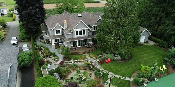 Aerial view of backyard landscape with flagstone pathways and stream