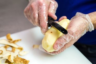 Hands peeling a potato close-up