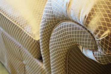 Close-up of a patterned fabric sofa armrest.