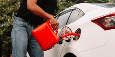 A Person Filling The Tank Of A Car With A Fuel Tank
