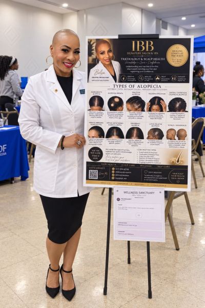 Professional woman presenting alopecia education poster.