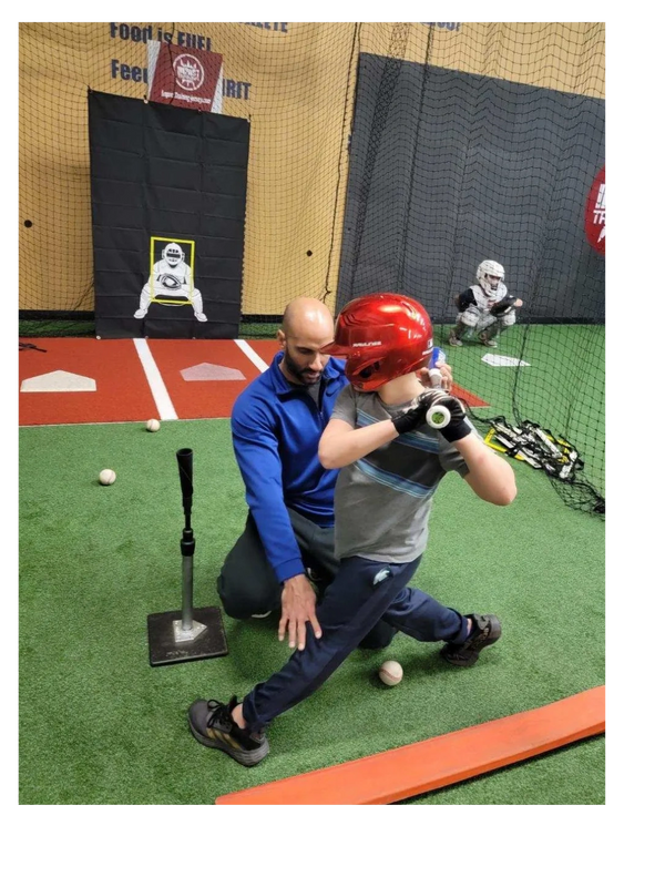 Jose working on batter's stride during his baseball hitting lesson.