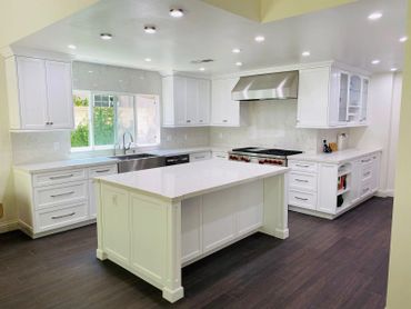 Kitchen with white cabinets, quartz countertops, center island, and stainless steel appliances