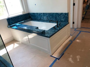Bathtub with blue/green granite top
