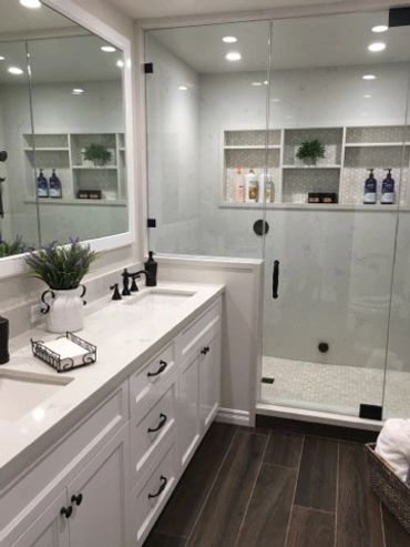 Beautiful white shower with with cabinets and shower with glass enclosure