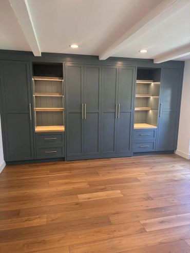 Beautiful wall to wall cabinets with doors and drawers, and open shelving with LED lighting.