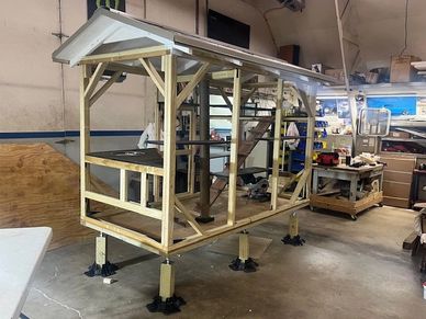 Wooden framework structure inside a workshop.