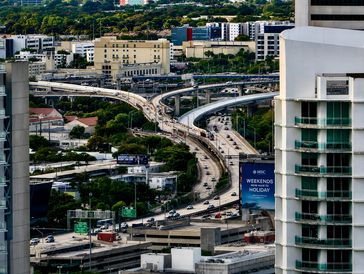 A busy urban highway interchange with multiple lanes and overpasses.
