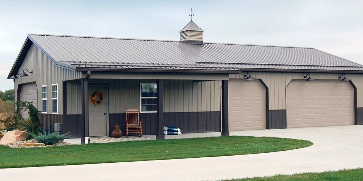 Enclosed Pole Barn built into a custom home with three garage doors.