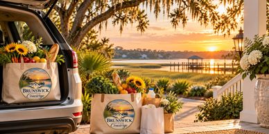Sunset with picnic bags and flowers by a lake.