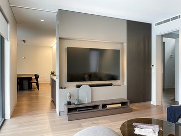 Floor to ceiling TV Joinery featuring hidden storage.