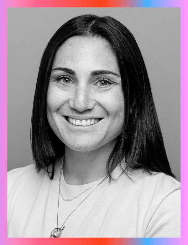 Smiling woman with straight dark hair in a black and white portrait.
