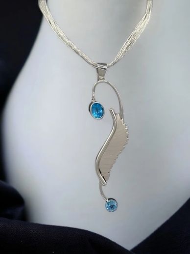 Icarus pendant with two large apatite faceted stones set in sterling silver dangling from a six-stra