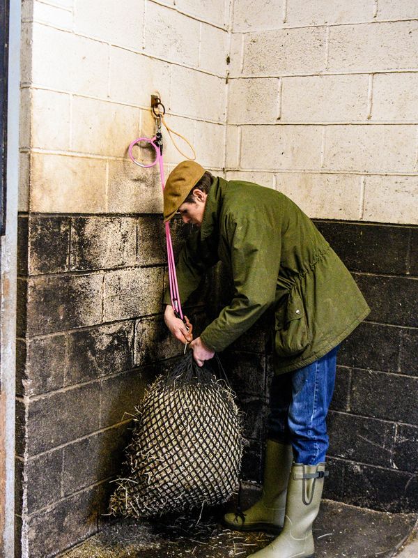 Man hooking a haynet using the EquiJack
