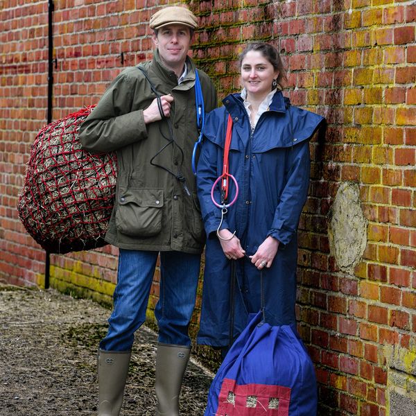 Husband and wife holding haynet and EquiJack