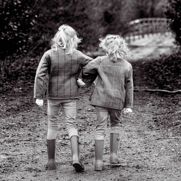 Two sisters walking down a track