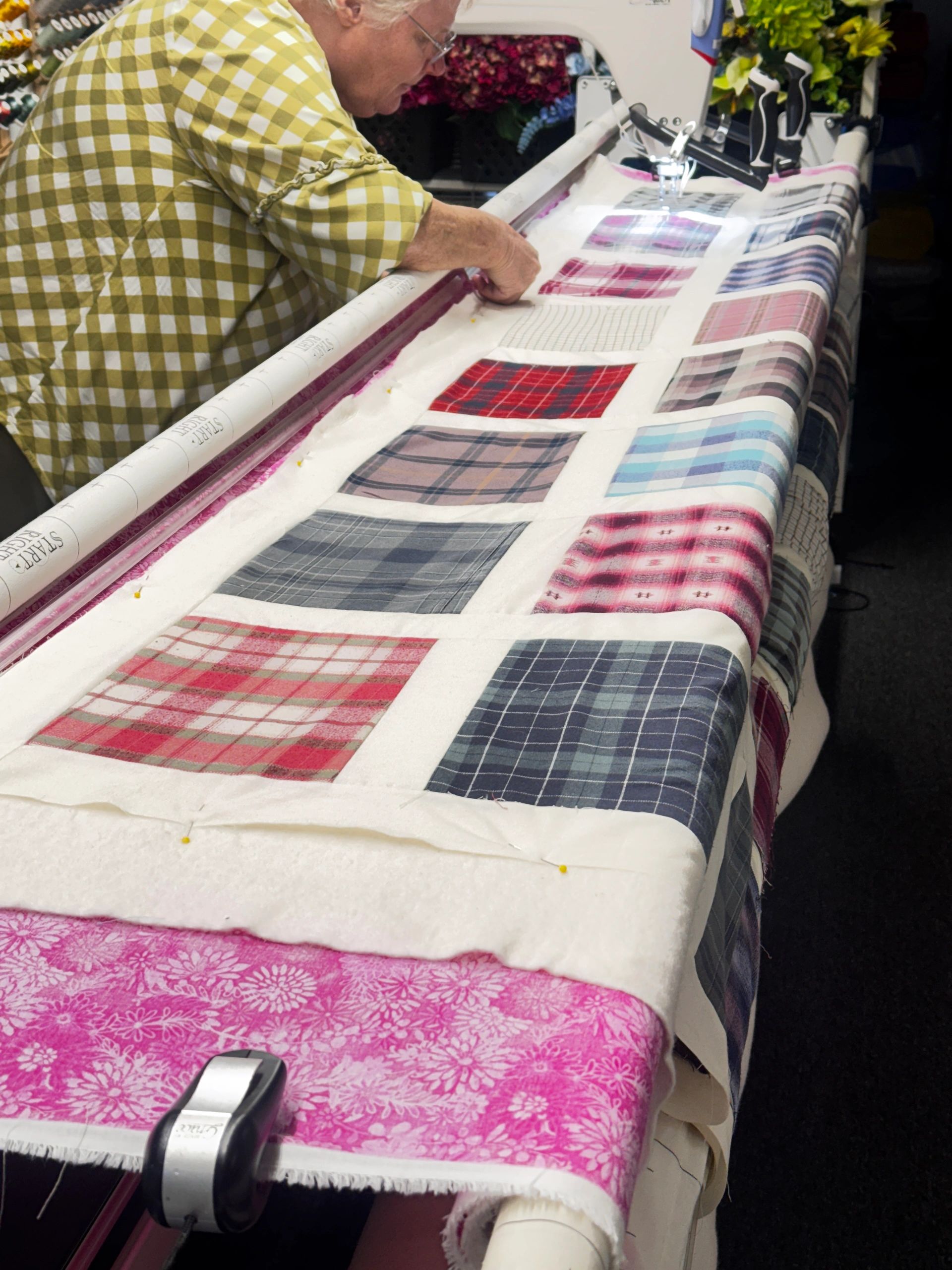 Tammy loading a quilt top in  the long arm quilter.