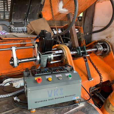 Welding and spring machine setup inside industrial equipment.