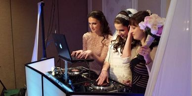 Bride getting a hands on experience to dj for a moment to connect with her guests