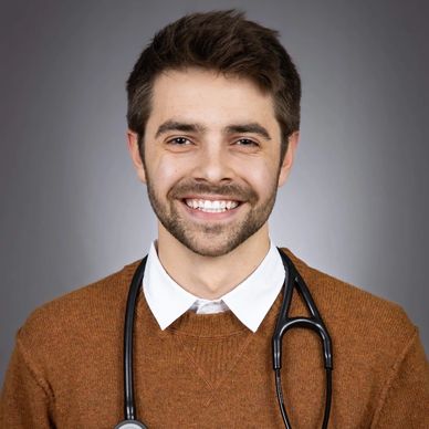 Smiling male doctor with a stethoscope around his neck.