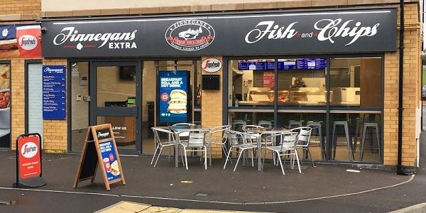 Outside image of Finnegans Extra Fish & Chips Shop with seating area.