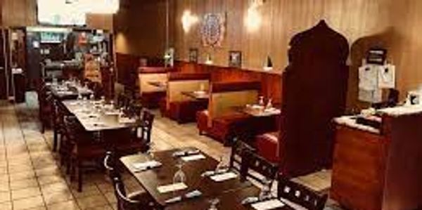 Cozy restaurant interior with wooden tables and booths.