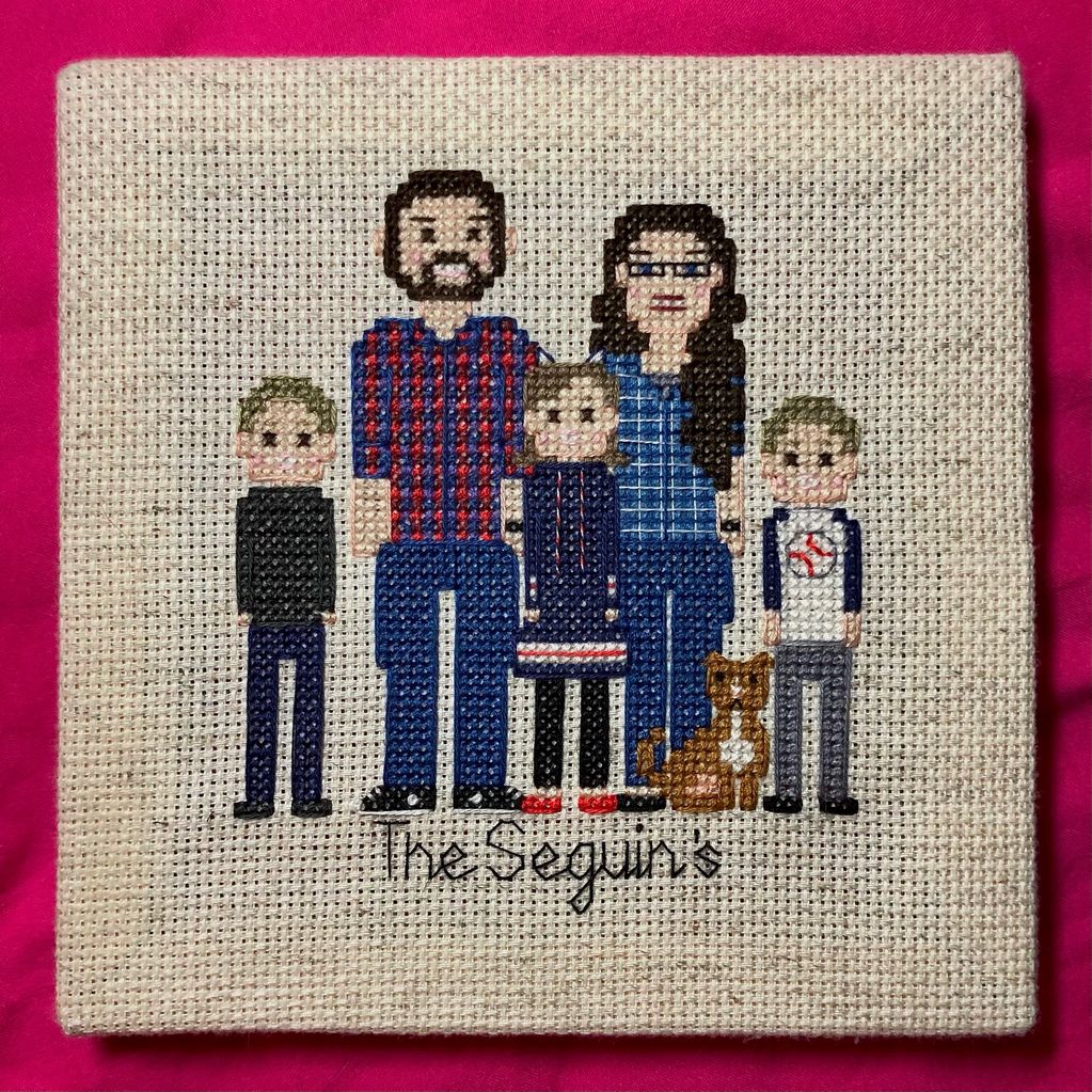 Cross stitch portrait of a family of 5 and their dog.