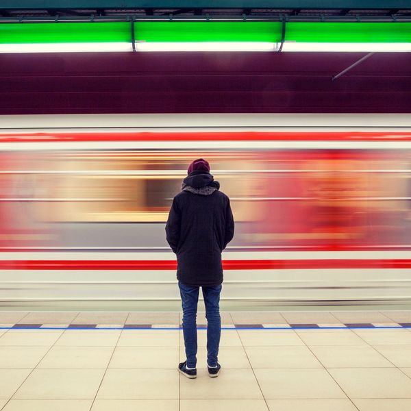 Photo of a person being left behind at a train station