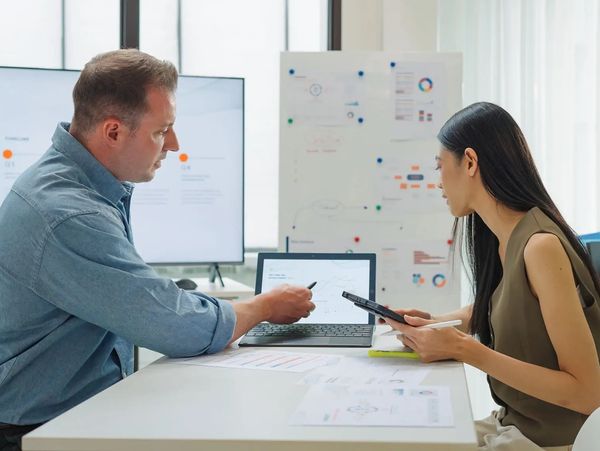 Team analyzing digital data charts.