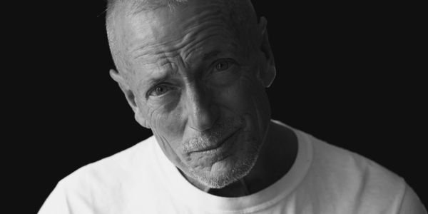 A subject posing for a professional headshot photographer.