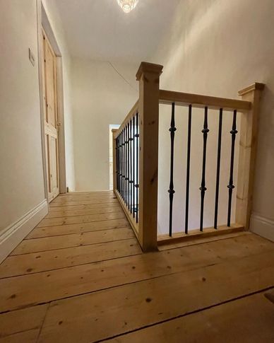 Pine staircase with metal spindles installed in St Albans, Hertfordshire.