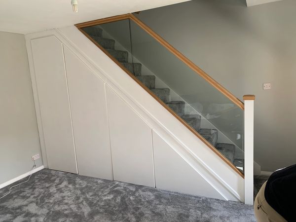 White and oak staircase with under stair storage installed in Tring, Hertfordshire.