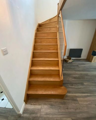 White with Oak mop stick handrails and frameless glass installed in Kings Langley,  Hertfordshire.