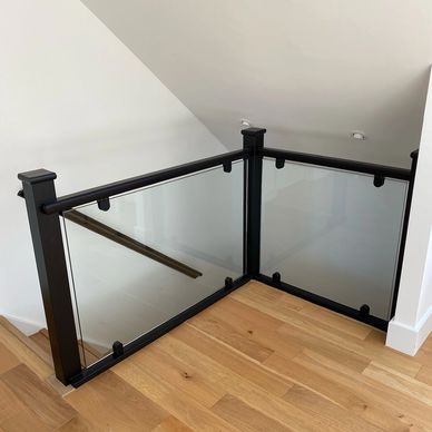 Black staircase with 10mm glass black glass brackets installed in Welwyn Garden City, Hertfordshire 