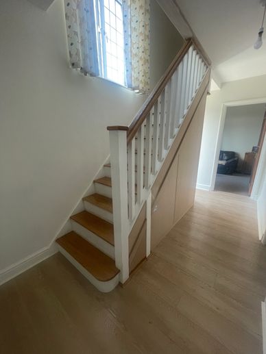 White and oak stair refurb with under stair storage in Hemel Hempstead, Hertfordshire